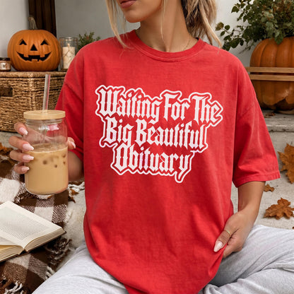Red t-shirt with &amp;quot;Waiting For The Big Beautiful Obituary&amp;quot; text.