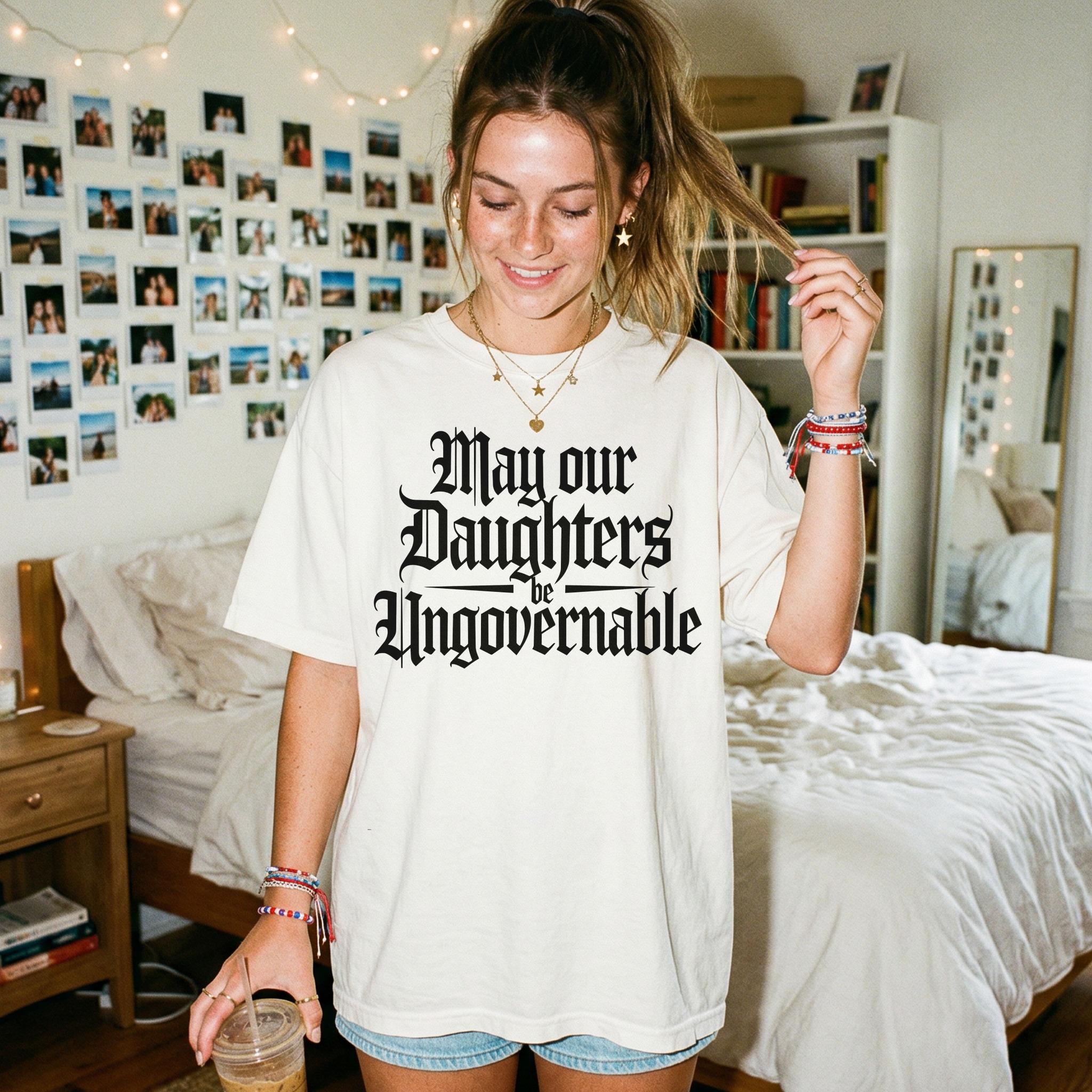 Cream t-shirt with gothic font text &amp;quot;May our Daughters be Ungovernable.&amp;quot;
