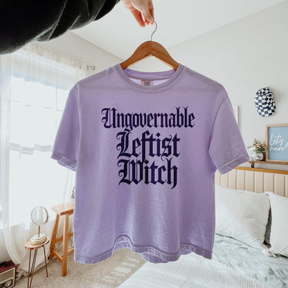 Lavender t-shirt with &amp;quot;Ungovernable Leftist Witch&amp;quot; text in gothic font.