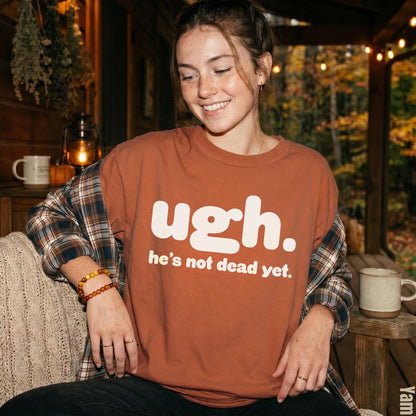 Rust-colored t-shirt with white text &amp;quot;ugh. he&amp;