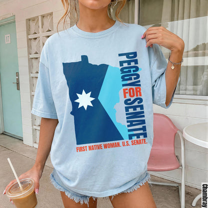 Light blue t-shirt with Peggy for Senate, First Native Woman U.S. Senate graphic.