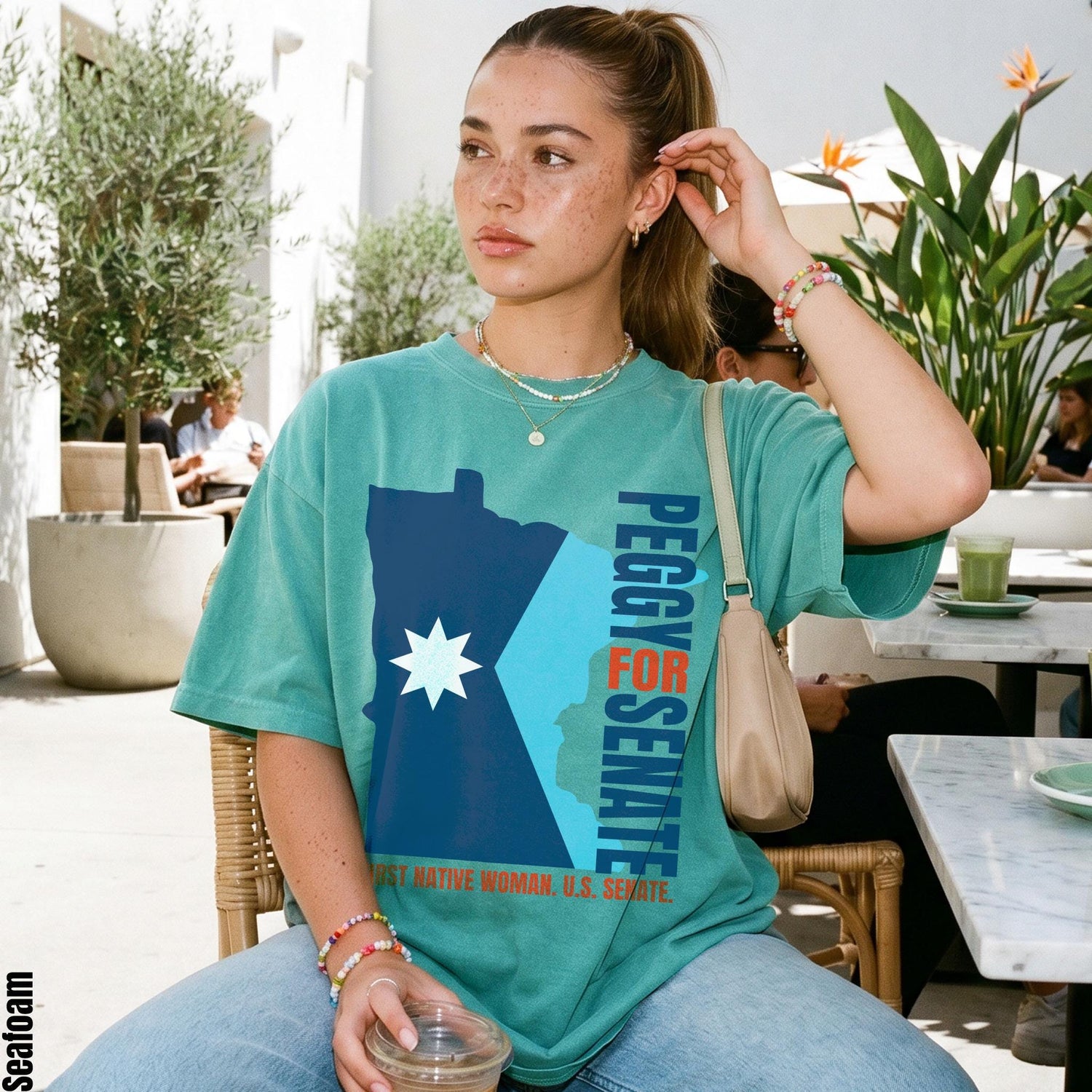 Teal t-shirt with &amp;quot;Peggy for Senate&amp;quot; and &amp;quot;First Native Woman, U.S. Senate&amp;quot; text.