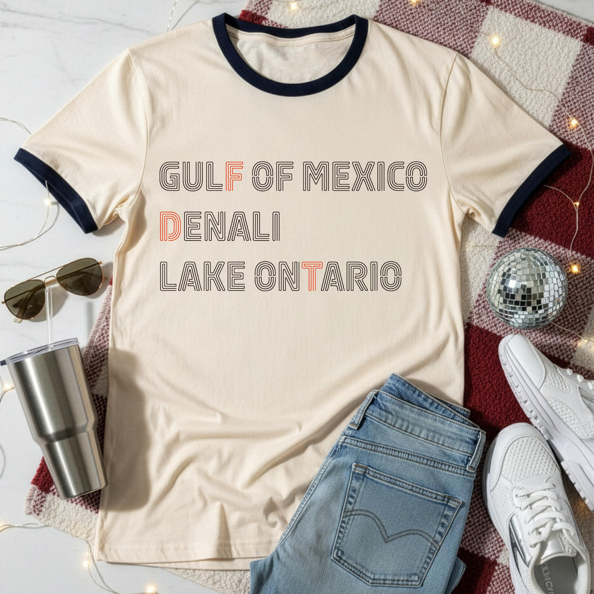 Cream ringer tee with &amp;quot;GULF OF MEXICO DENALI LAKE ONTARIO&amp;quot; text.