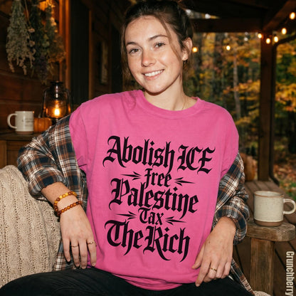Pink t-shirt with black text reading &amp;quot;Abolish ICE&amp;quot;, &amp;quot;free Palestine&amp;quot;, &amp;quot;Tax The Rich&amp;quot;.