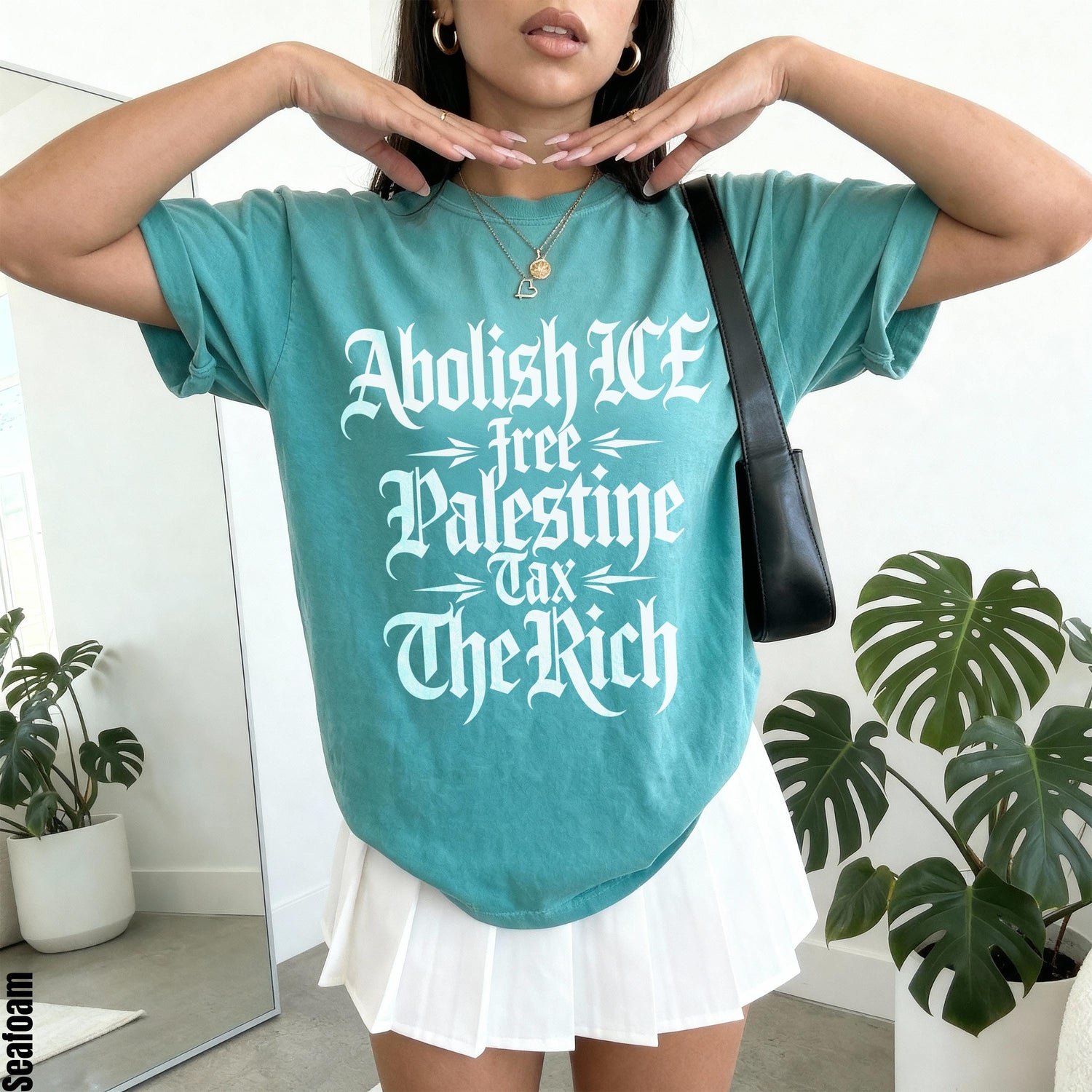 Teal t-shirt with white text reading &amp;quot;Abolish ICE, Free Palestine, Tax The Rich&amp;quot;.