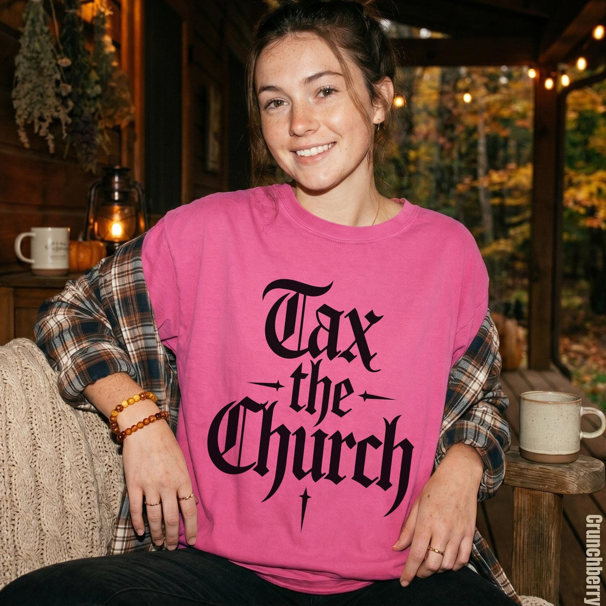 Pink sweatshirt with black gothic text reading &amp;quot;Tax the Church&amp;quot;.