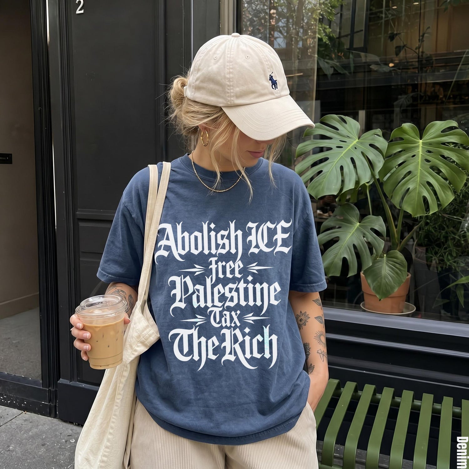 Woman wearing navy t-shirt with &amp;quot;Abolish ICE Free Palestine Tax The Rich&amp;quot; text.