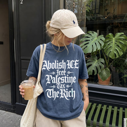 Woman wearing navy t-shirt with &amp;quot;Abolish ICE Free Palestine Tax The Rich&amp;quot; text.