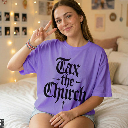 Woman wearing a purple t-shirt with black text reading &amp;quot;Tax the Church.&amp;quot;