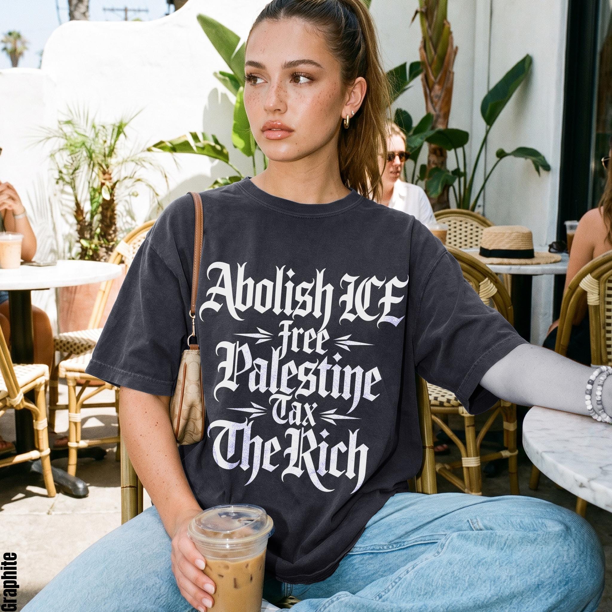 Dark gray t-shirt with white gothic text: Abolish ICE, Free Palestine, Tax The Rich.