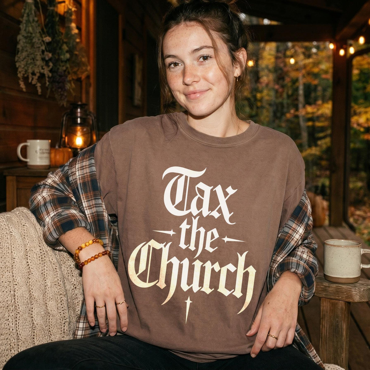 Brown t-shirt with white gothic text reading &amp;quot;Tax the Church&amp;quot;.