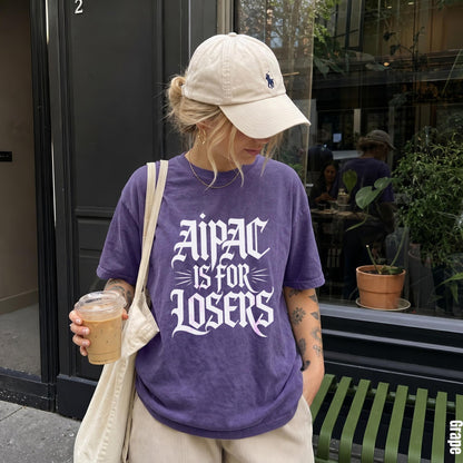 Purple t-shirt with &amp;quot;Aipac is for Losers&amp;quot; text, beige hat, and iced coffee.