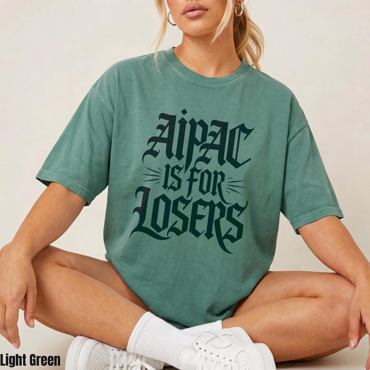 Green t-shirt with gothic text reading &amp;quot;Aipac is for losers.&amp;quot;