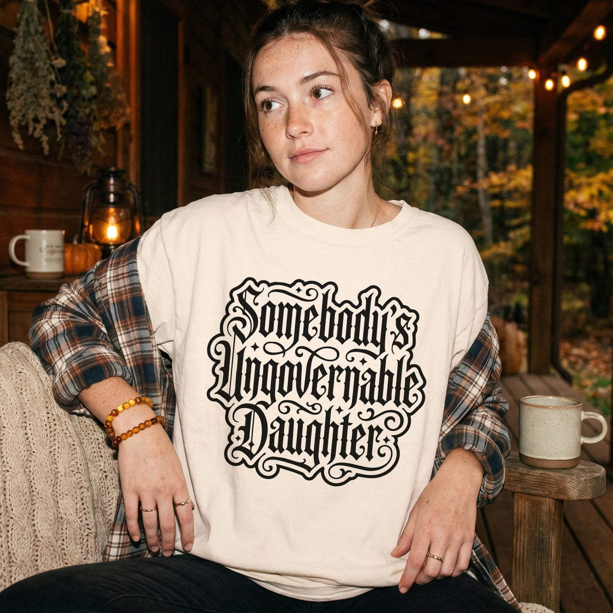Cream t-shirt with black gothic text reading &amp;quot;Somebody&amp;