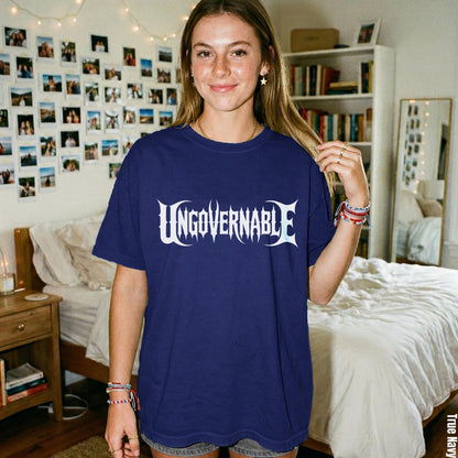 Woman in navy blue t-shirt with &amp;quot;UNGOVERNABLE&amp;quot; graphic, standing in a bedroom.