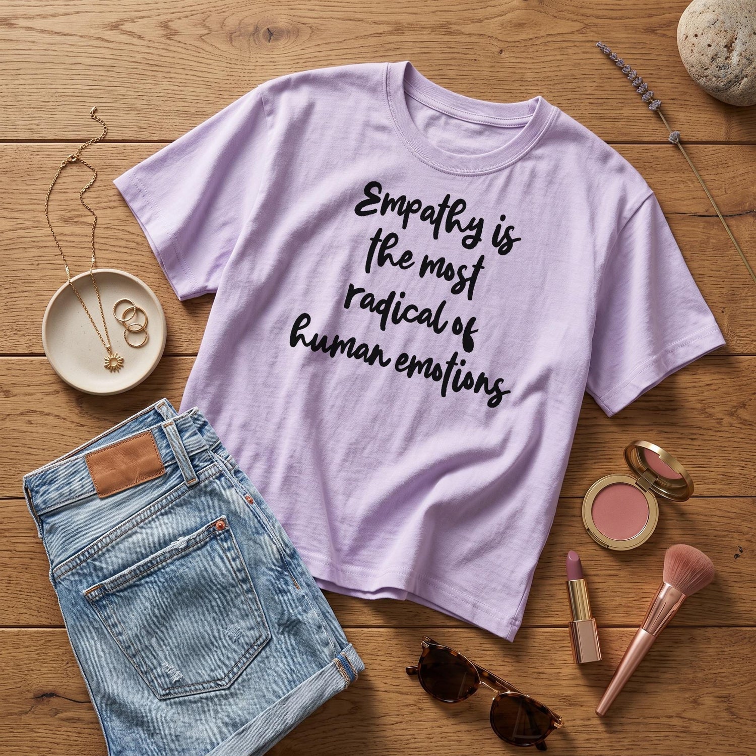 Lavender t-shirt with &amp;quot;Empathy is the most radical of human emotions&amp;quot; text, denim shorts, and jewelry.