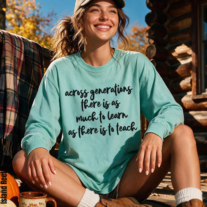 Woman wearing a mint long-sleeve shirt with &amp;quot;across generations there is as much to learn as there is to teach&amp;quot; text.