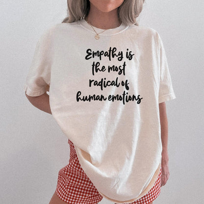 Cream t-shirt with black text reading &amp;quot;Empathy is the most radical of human emotions&amp;quot;.