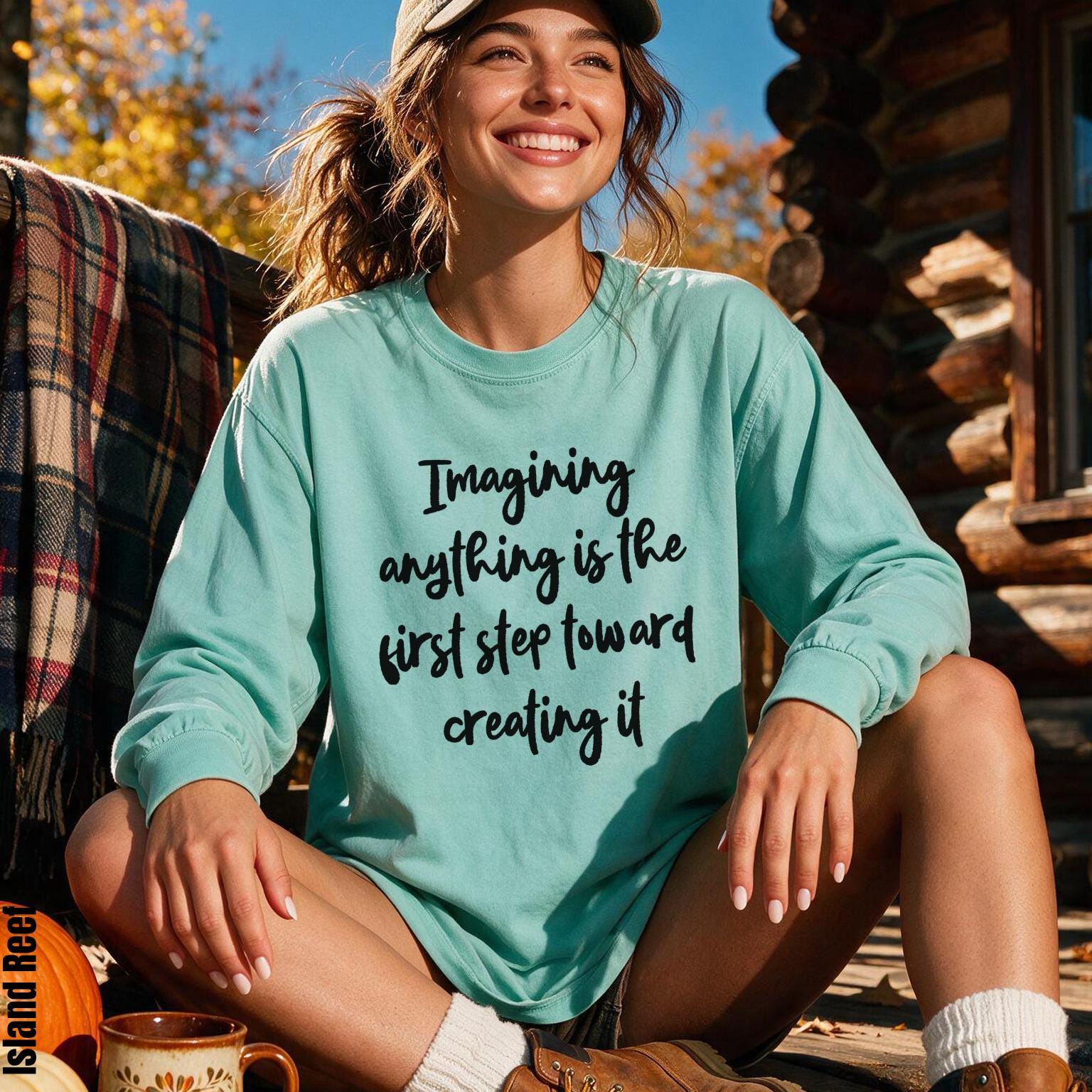 Mint green long-sleeve shirt with &amp;quot;Imagining anything is the first step toward creating it&amp;quot; text.