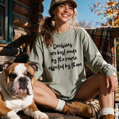 Woman wearing sage green long-sleeve shirt with text &amp;quot;Decisions are best made by the people affected by them.&amp;quot;