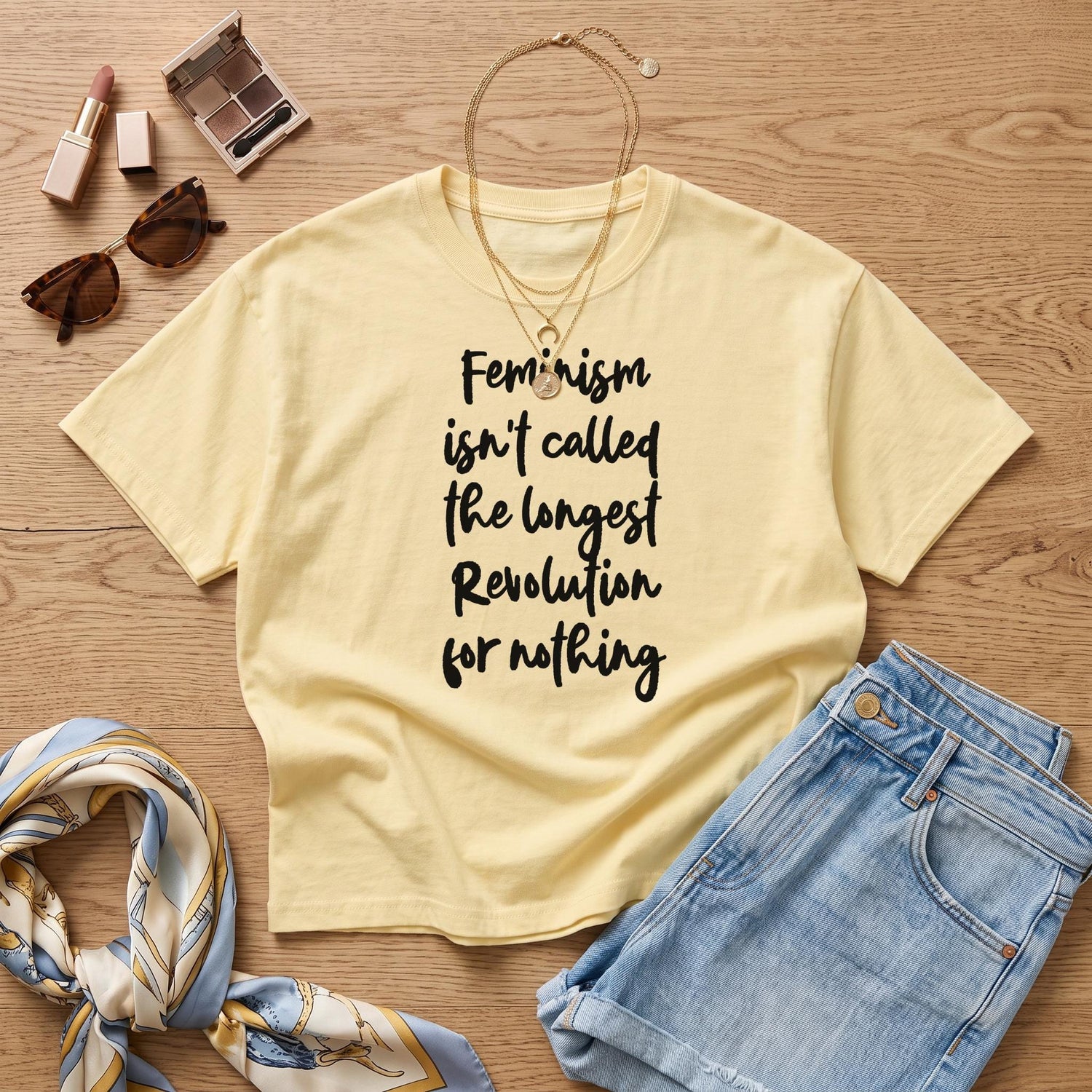 Pale yellow t-shirt with black text reading &amp;quot;Feminism isn&amp;