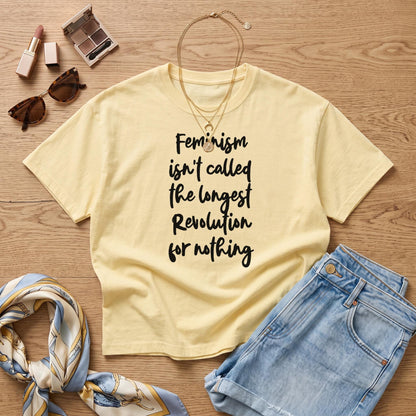 Pale yellow t-shirt with black text reading &amp;quot;Feminism isn&amp;
