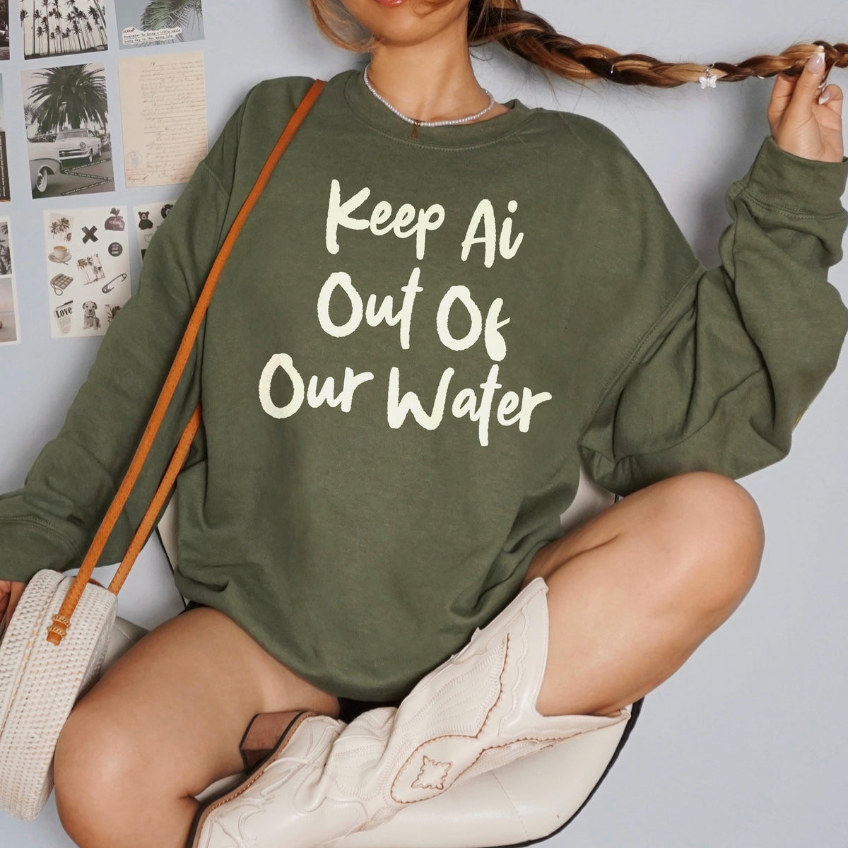 Olive sweatshirt with white text &amp;quot;Keep Ai Out Of Our Water&amp;quot;.