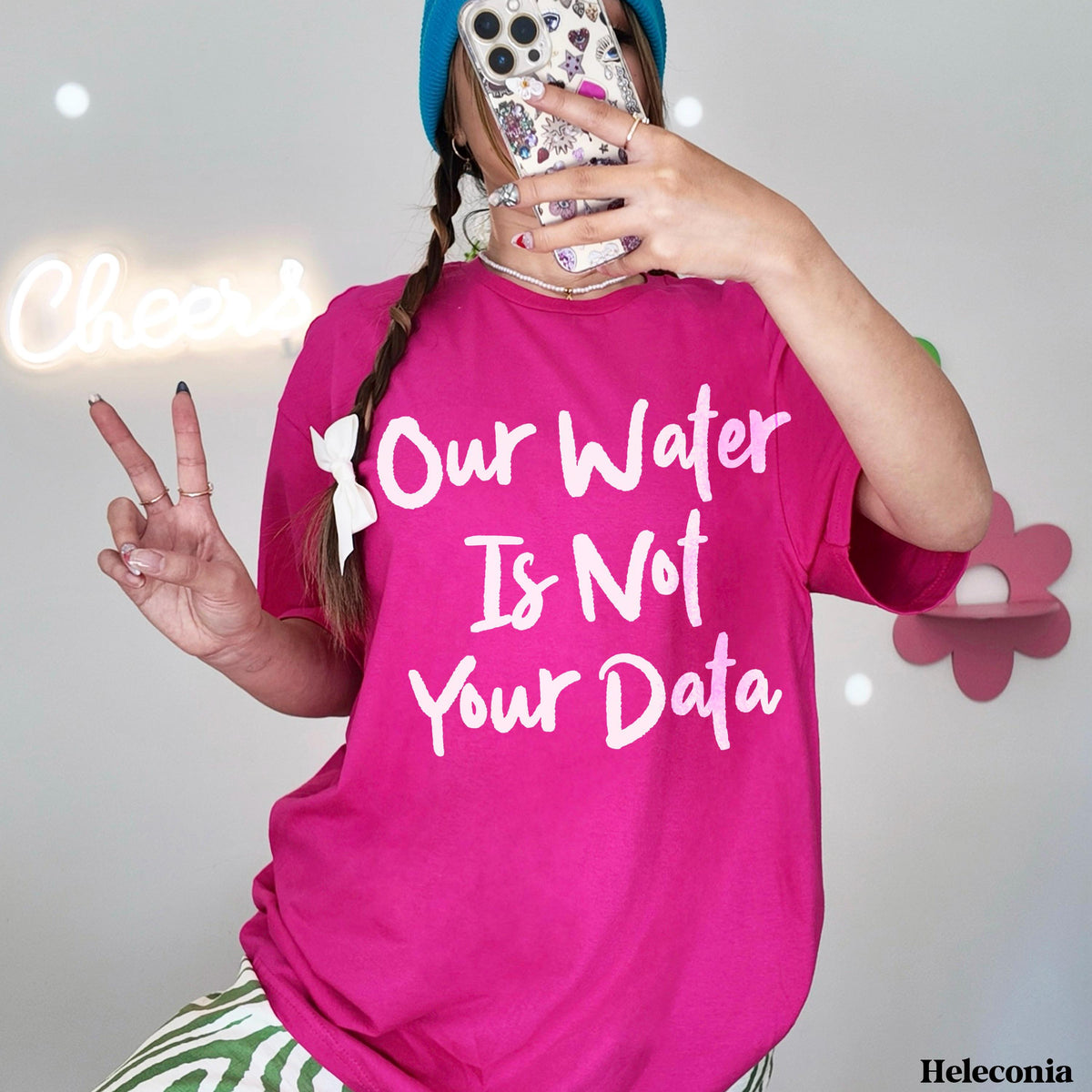 Woman in pink t-shirt with white text &amp;quot;Our Water Is Not Your Data&amp;quot;.