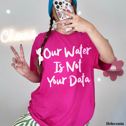 Woman in pink t-shirt with white text &amp;quot;Our Water Is Not Your Data&amp;quot;.
