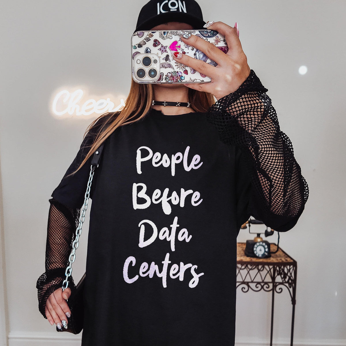 Black t-shirt with white text &amp;quot;People Before Data Centers&amp;quot;.