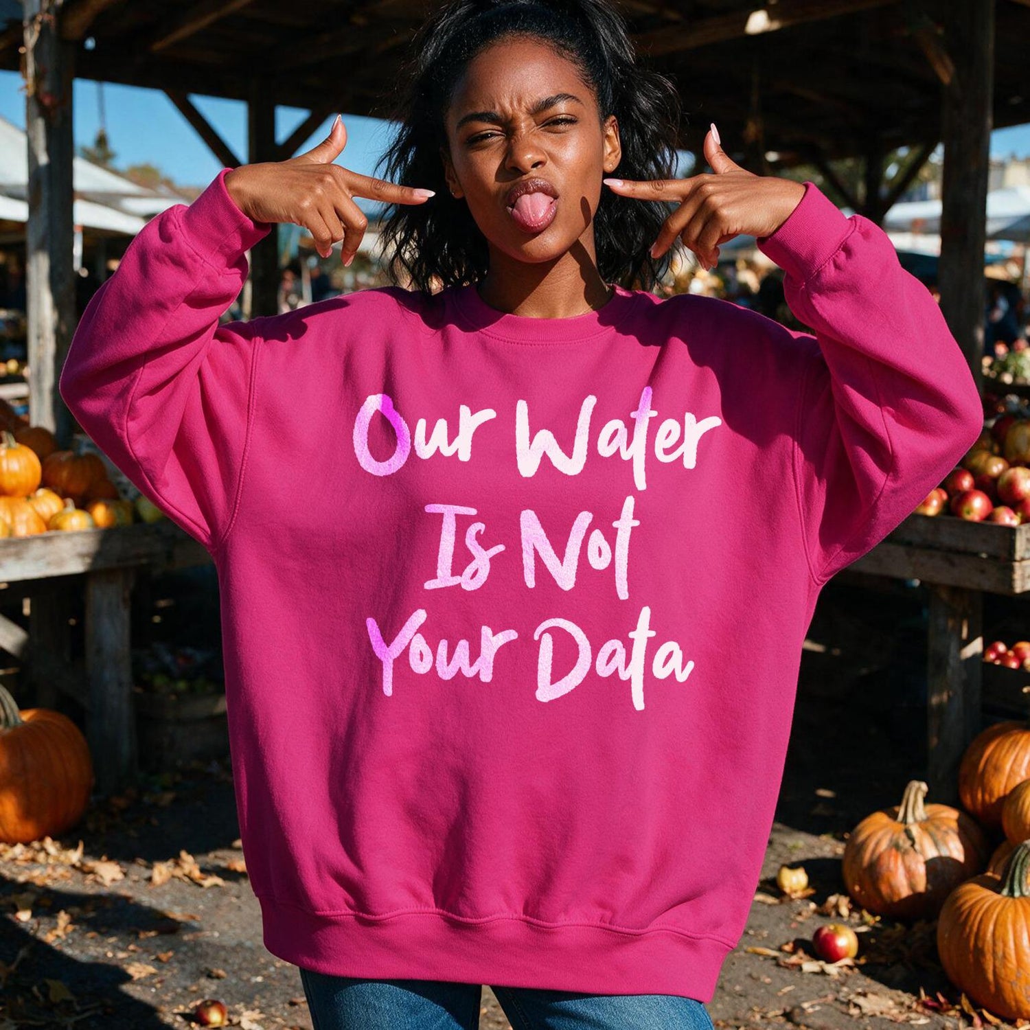 Woman wearing a pink sweatshirt with &amp;quot;Our Water Is Not Your Data&amp;quot; text.