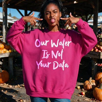 Woman wearing a pink sweatshirt with &amp;quot;Our Water Is Not Your Data&amp;quot; text.