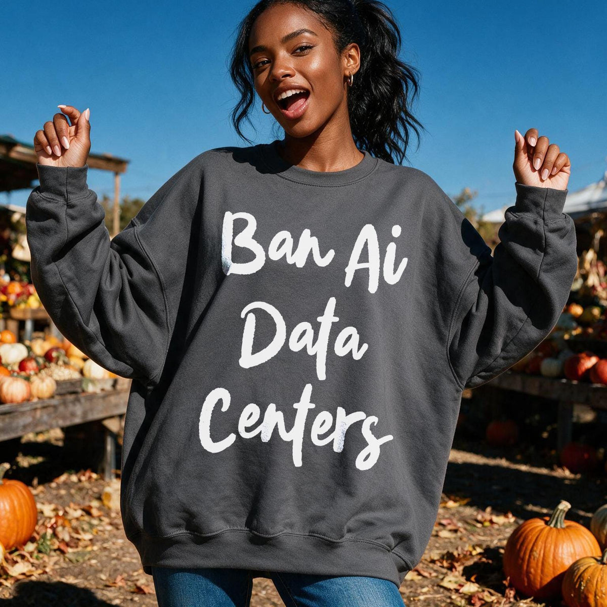 Dark gray sweatshirt with &amp;quot;Ban Ai Data Centers&amp;quot; text, on a woman outdoors with pumpkins.