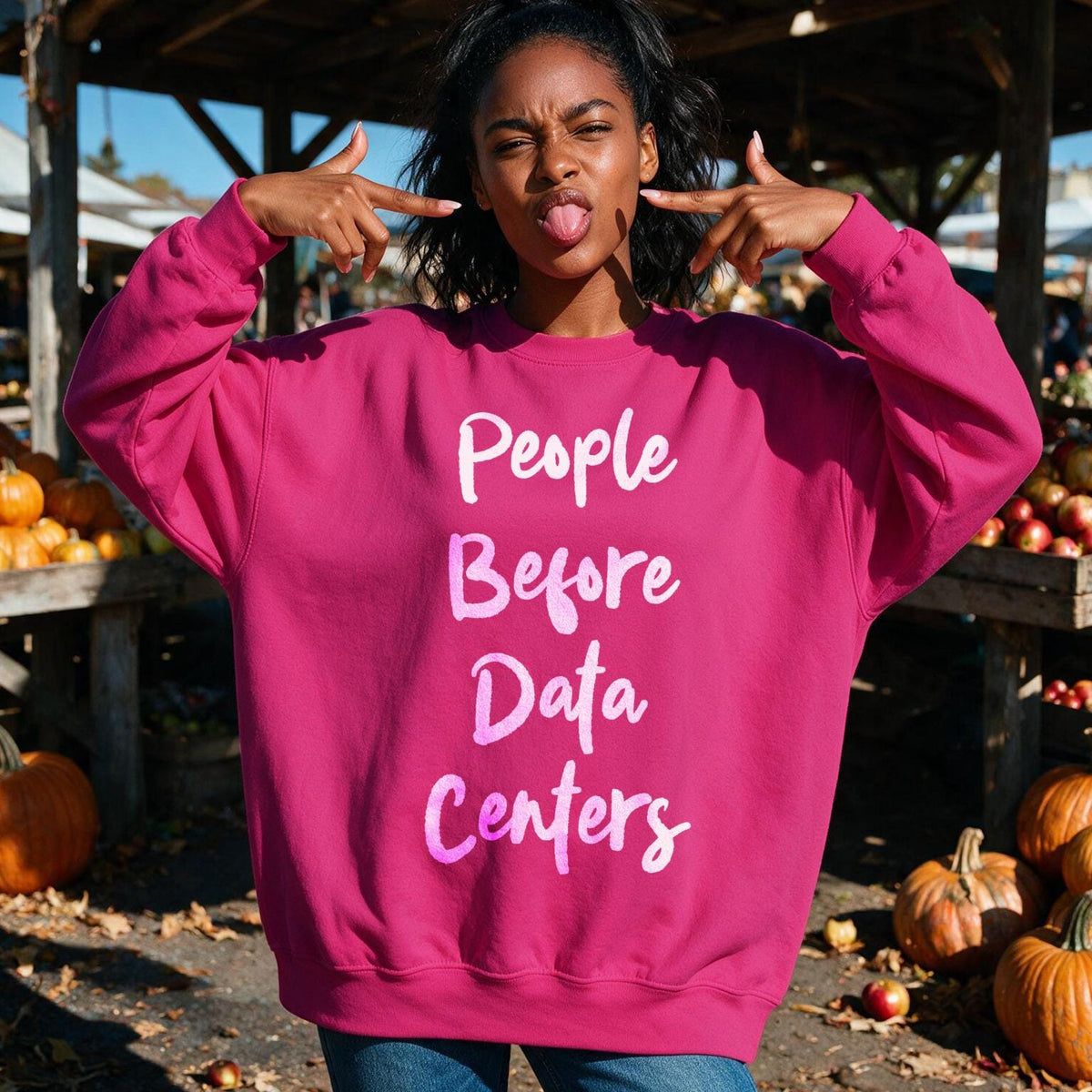 Woman in pink sweatshirt with &amp;quot;People Before Data Centers&amp;quot; text.