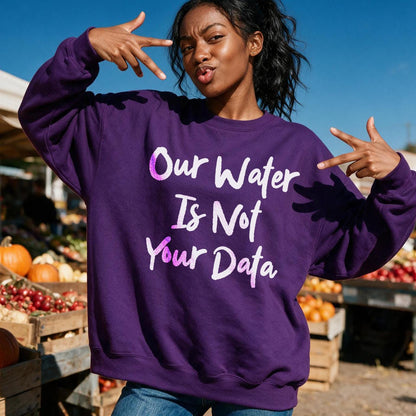 Purple sweatshirt with white text &amp;quot;Our Water Is Not Your Data&amp;quot; on it.