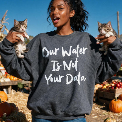 Woman in dark sweatshirt holding two kittens, text reads &amp;quot;Our Water Is Not Your Data&amp;quot;.