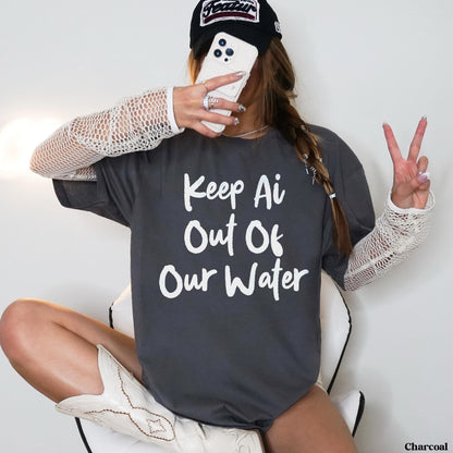 Charcoal t-shirt with &amp;quot;Keep Ai Out Of Our Water&amp;quot; text, worn by a person holding a phone.