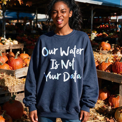 Navy sweatshirt with &amp;quot;Our Water Is Not Your Data&amp;quot; text, featuring pumpkins.