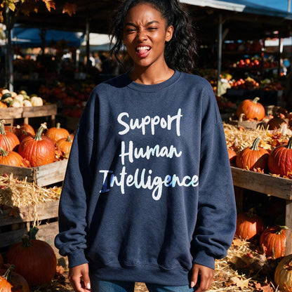 Dark blue sweatshirt with white text &amp;quot;Support Human Intelligence&amp;quot; on a backdrop of pumpkins.