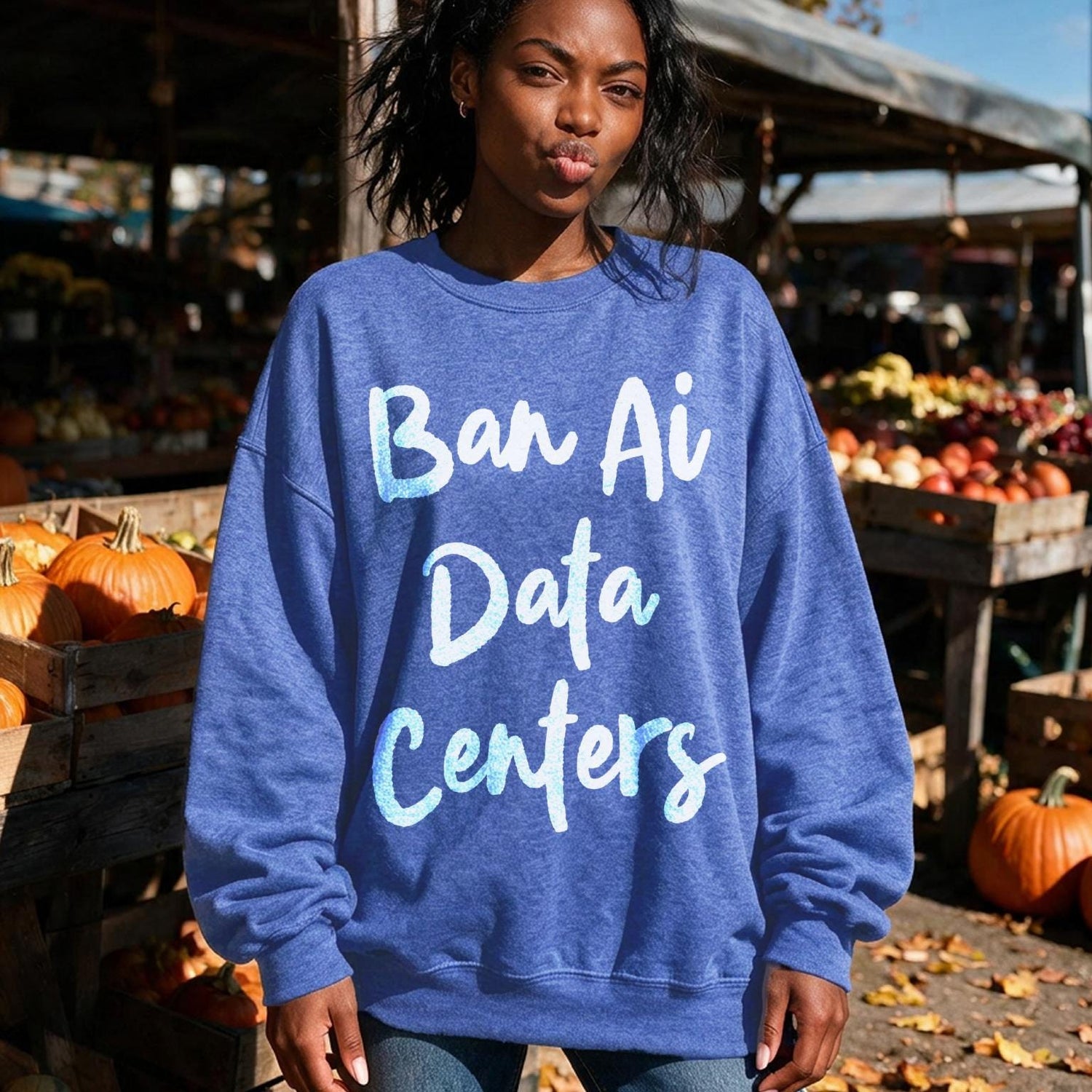 Woman wearing blue sweatshirt with &amp;quot;Ban Ai Data Centers&amp;quot; text.
