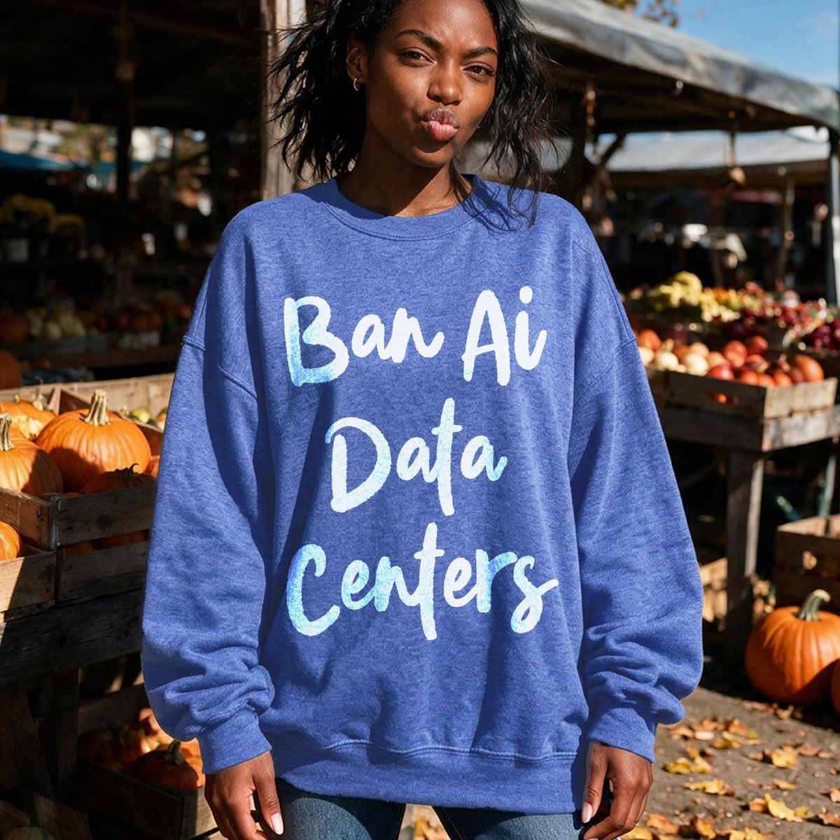Woman wearing blue sweatshirt with &amp;quot;Ban Ai Data Centers&amp;quot; text.