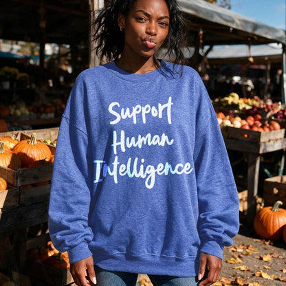 Blue sweatshirt with &amp;quot;Support Human Intelligence&amp;quot; text on a woman in an outdoor market.
