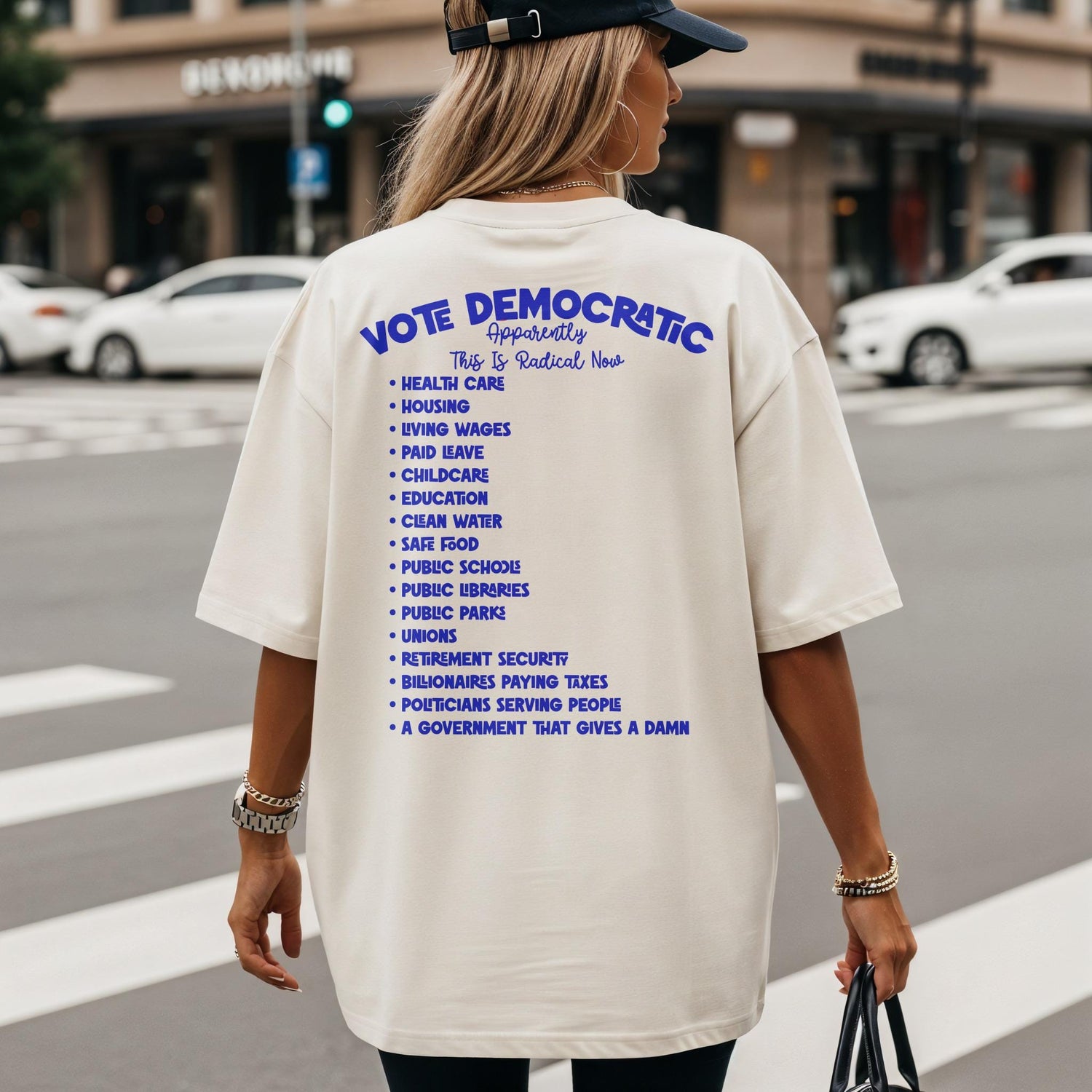 Cream t-shirt with blue text: &amp;quot;Vote Democratic Apparently This Is Radical Now&amp;quot; and a list of policies.
