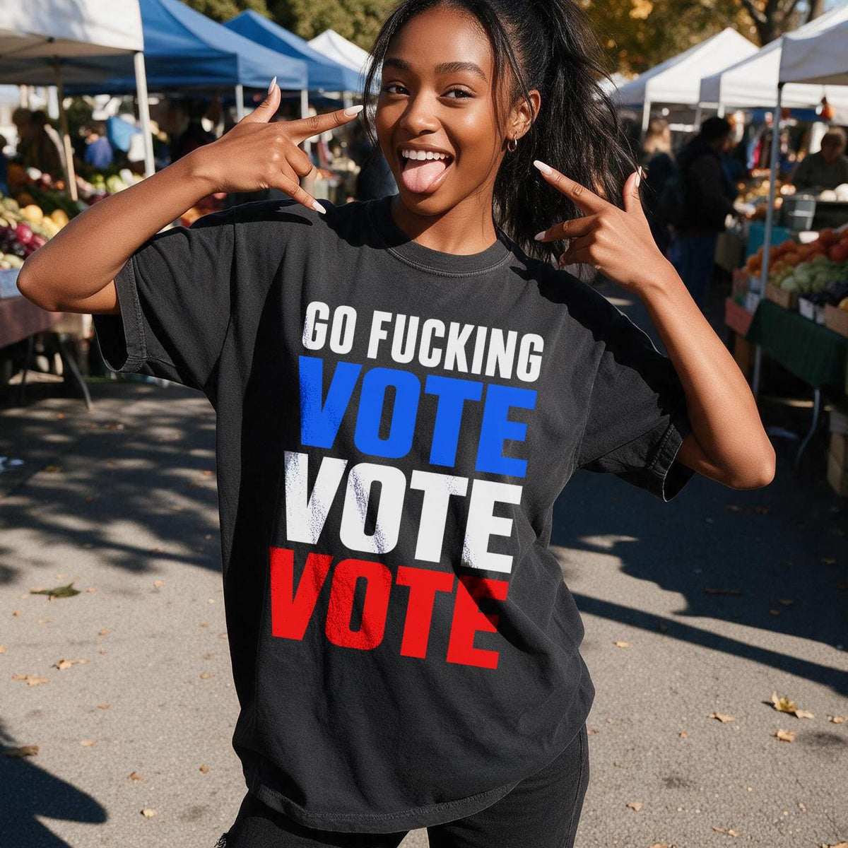 Woman in black t-shirt with &amp;quot;GO FUCKING VOTE&amp;quot; text, outdoors at a market.