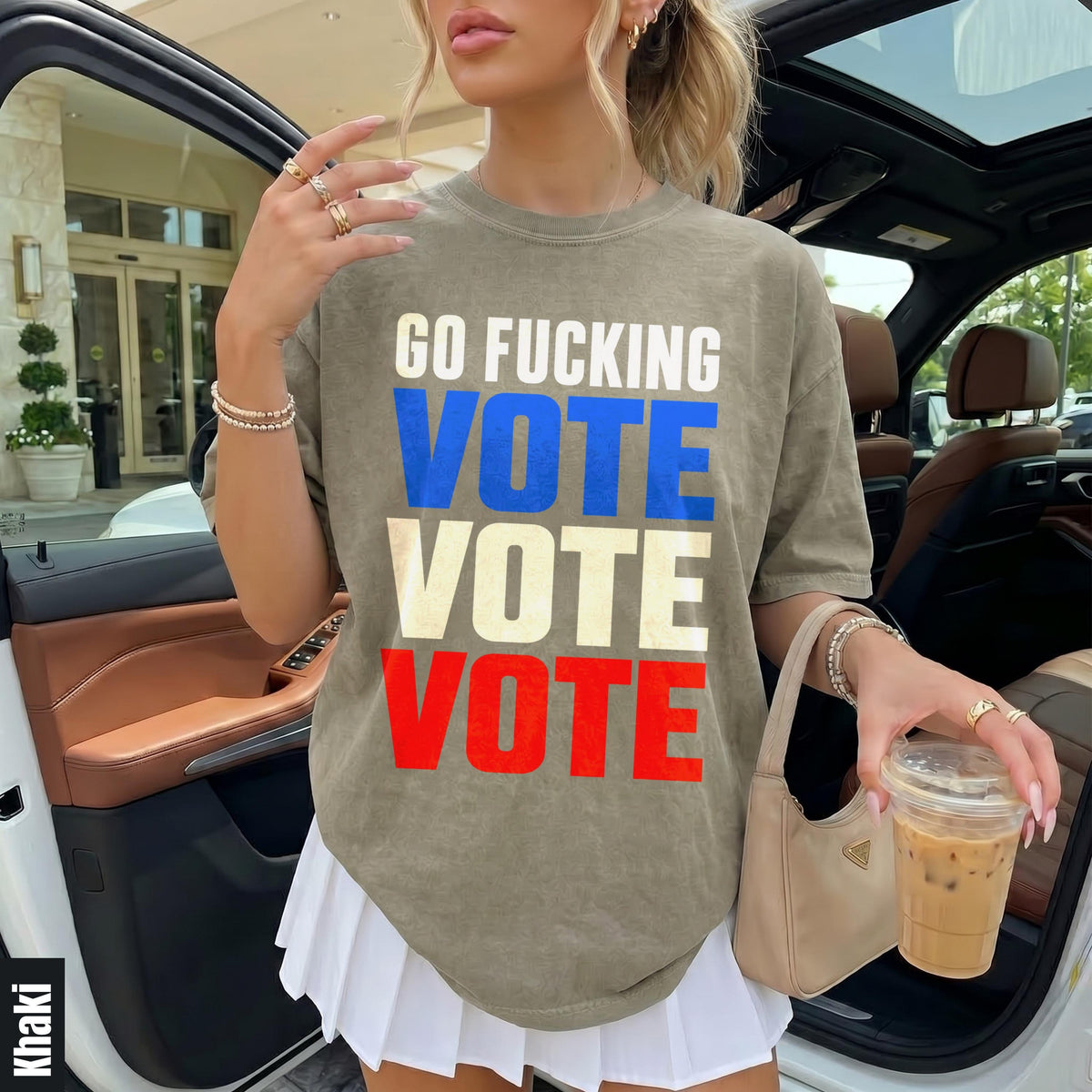 Woman in khaki shirt with &amp;quot;GO FUCKING VOTE&amp;quot; text and white pleated skirt.
