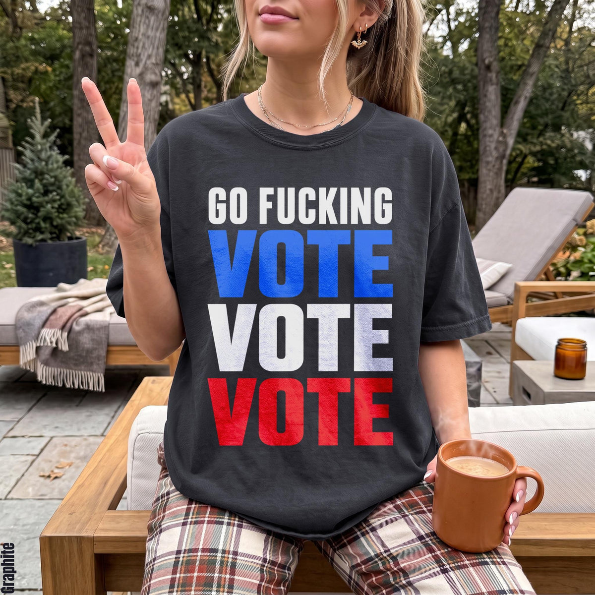 T-shirt with &amp;quot;GO FUCKING VOTE VOTE VOTE&amp;quot; text in patriotic colors, held by a person with a peace sign.