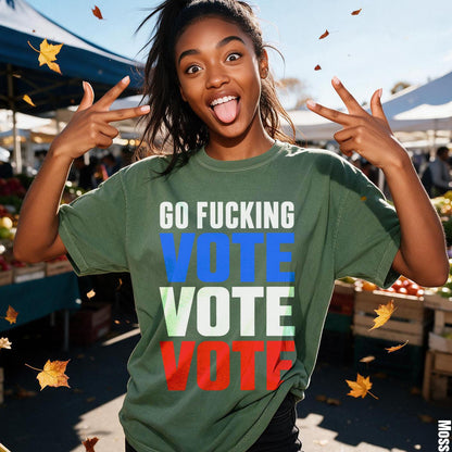 Woman wears green shirt with text &amp;quot;GO FUCKING VOTE&amp;quot; in colored letters.