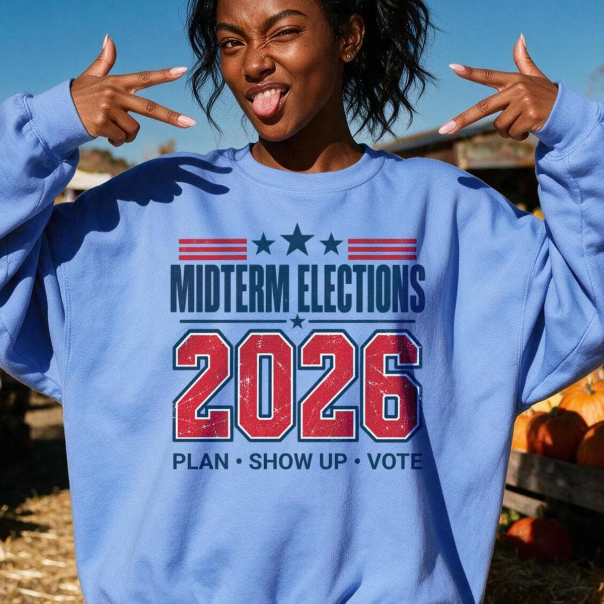 Light blue sweatshirt with &amp;quot;Midterm Elections 2026 Plan Show Up Vote&amp;quot; graphic.