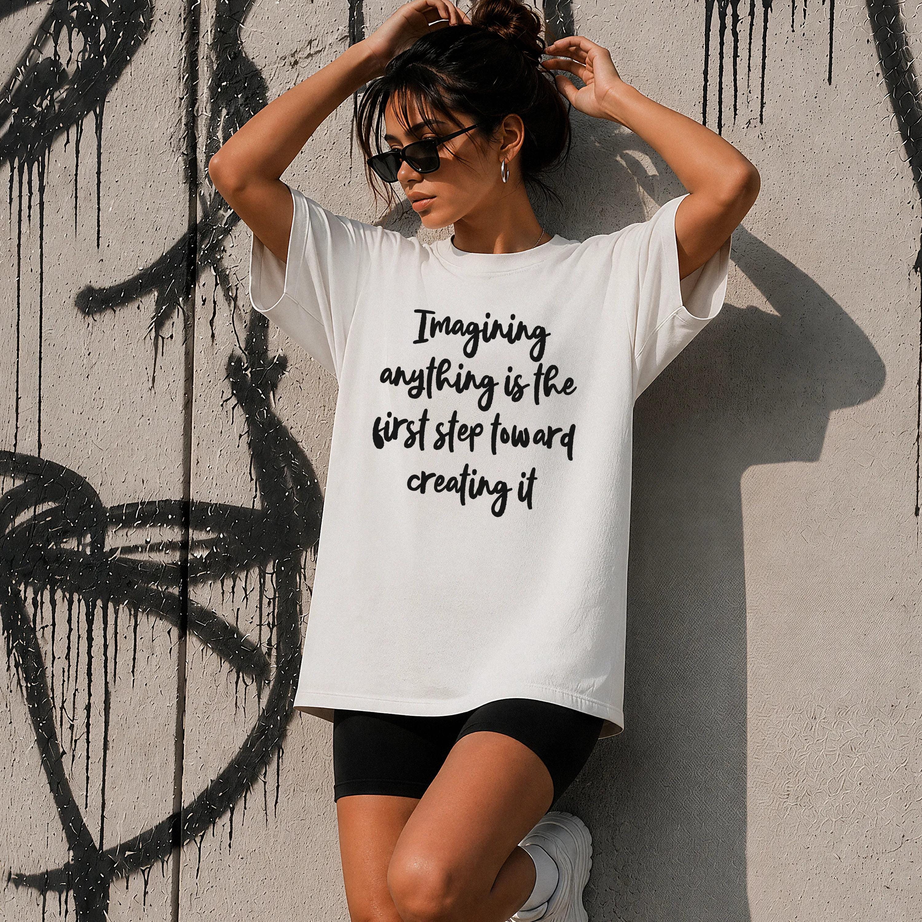 White t-shirt with black text: &amp;quot;Imagining anything is the first step toward creating it.&amp;quot;