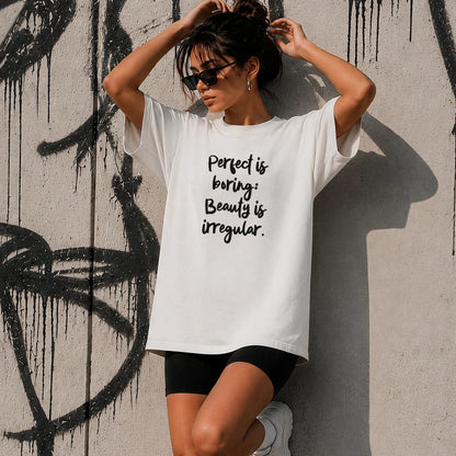 White t-shirt with &amp;quot;Perfect is boring: Beauty is irregular.&amp;quot; text over a graffiti wall.